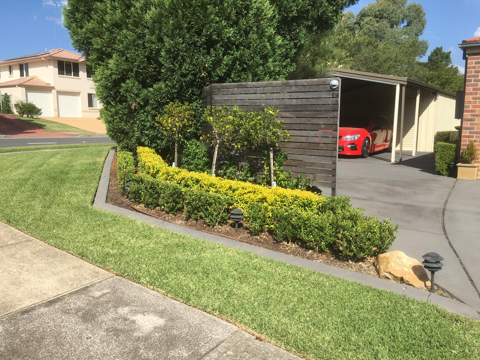 Garden maintenance job in Dural with a red car in the background